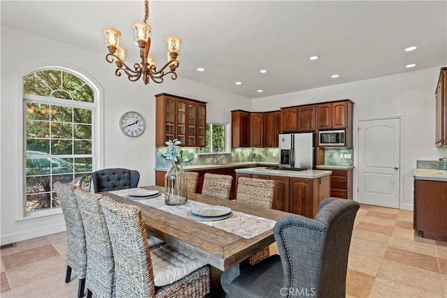 dining space with a chandelier and sink