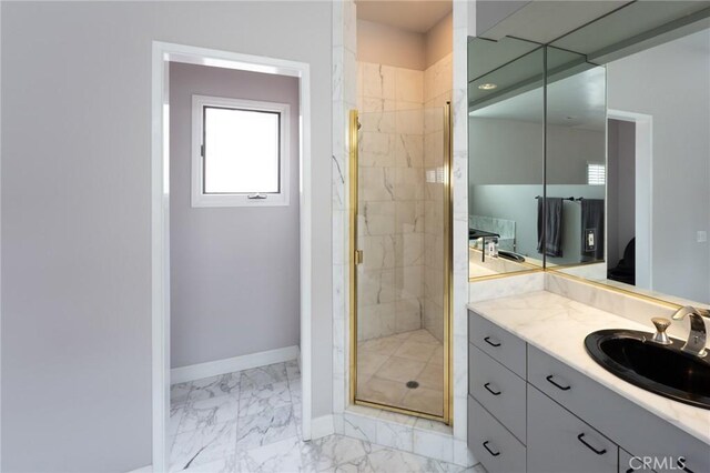 full bathroom featuring vanity, baseboards, a shower stall, and marble finish floor