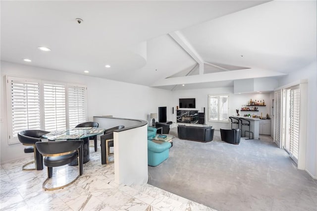 living area featuring recessed lighting, lofted ceiling with beams, and bar area