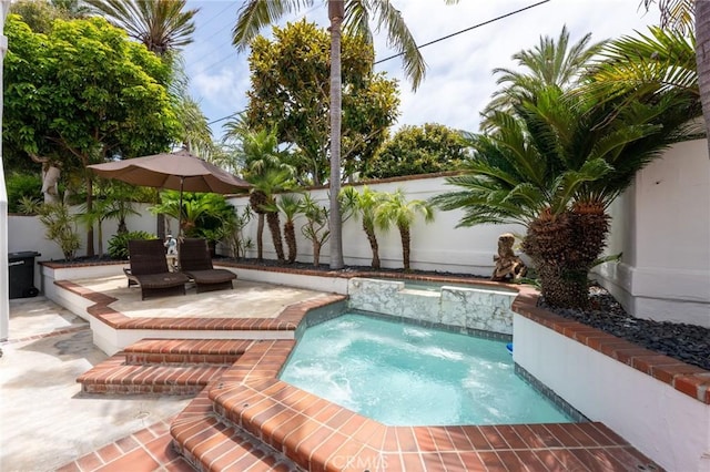 view of pool featuring a patio and a hot tub