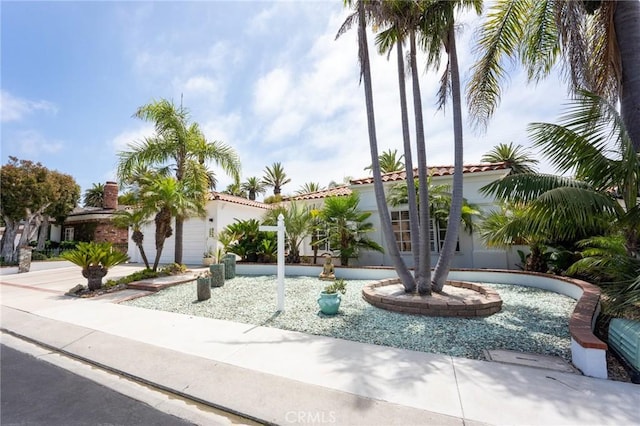 mediterranean / spanish house featuring stucco siding and a tile roof