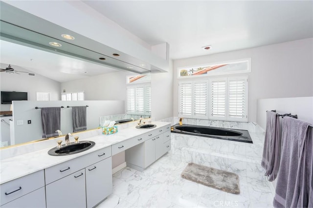 bathroom featuring vanity, ceiling fan, tiled bath, and vaulted ceiling