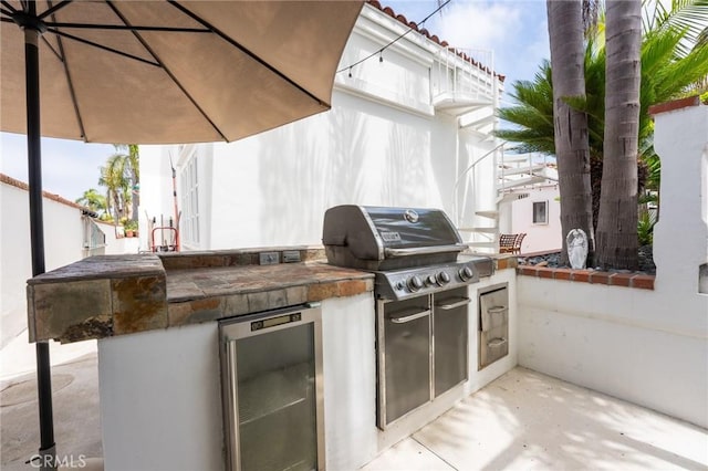 view of patio featuring exterior kitchen and grilling area