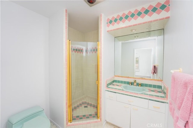 bathroom featuring vanity, toilet, tile patterned flooring, and a stall shower