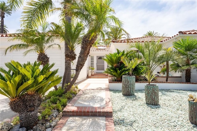 mediterranean / spanish-style house with a garage