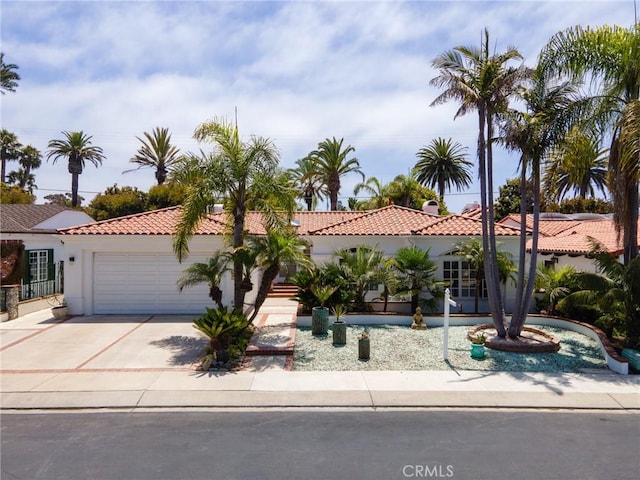 mediterranean / spanish home featuring a garage