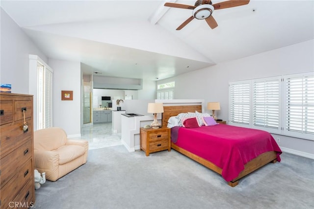 carpeted bedroom featuring baseboards, lofted ceiling with beams, a ceiling fan, and ensuite bath