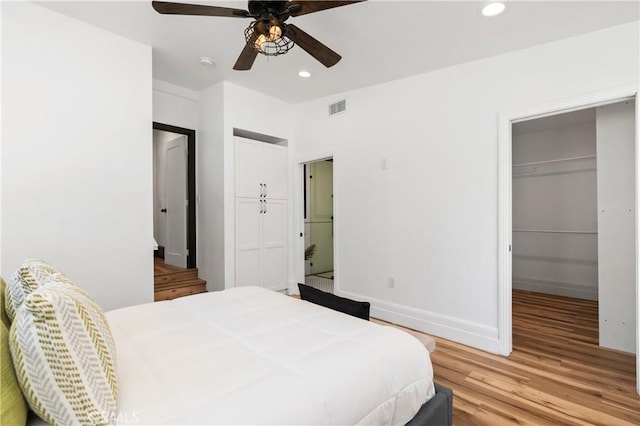 bedroom with ceiling fan and light hardwood / wood-style floors