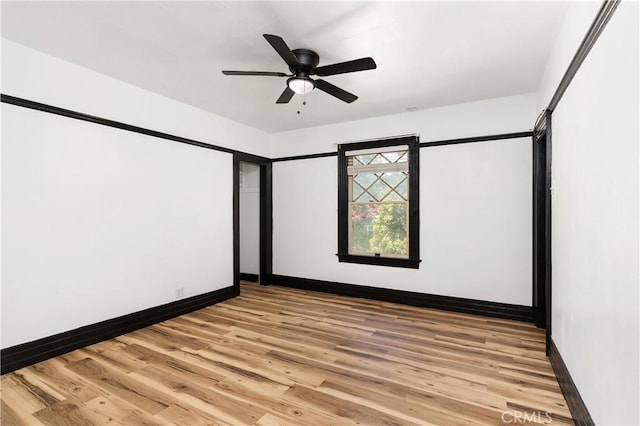 empty room featuring light hardwood / wood-style flooring and ceiling fan