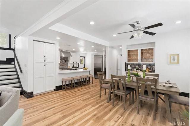 dining room with light hardwood / wood-style flooring and ceiling fan