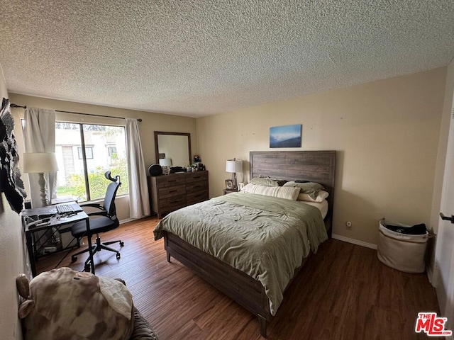 bedroom featuring hardwood / wood-style floors and a textured ceiling