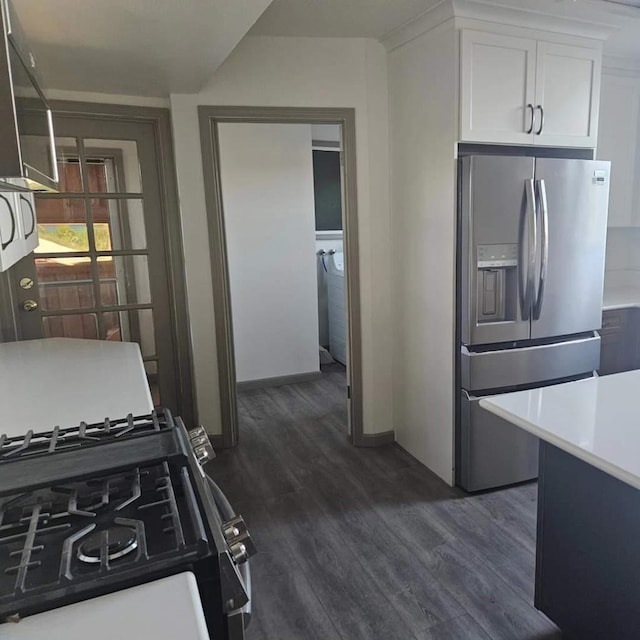 kitchen with stainless steel refrigerator with ice dispenser, white cabinets, dark hardwood / wood-style flooring, and range with gas stovetop