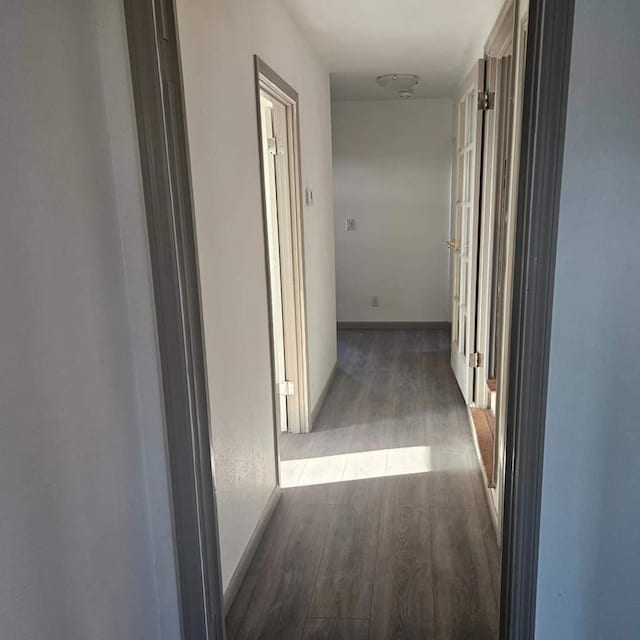 hallway with dark wood-type flooring