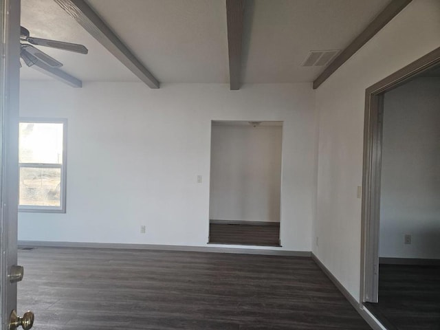 empty room with ceiling fan, dark hardwood / wood-style floors, and beamed ceiling