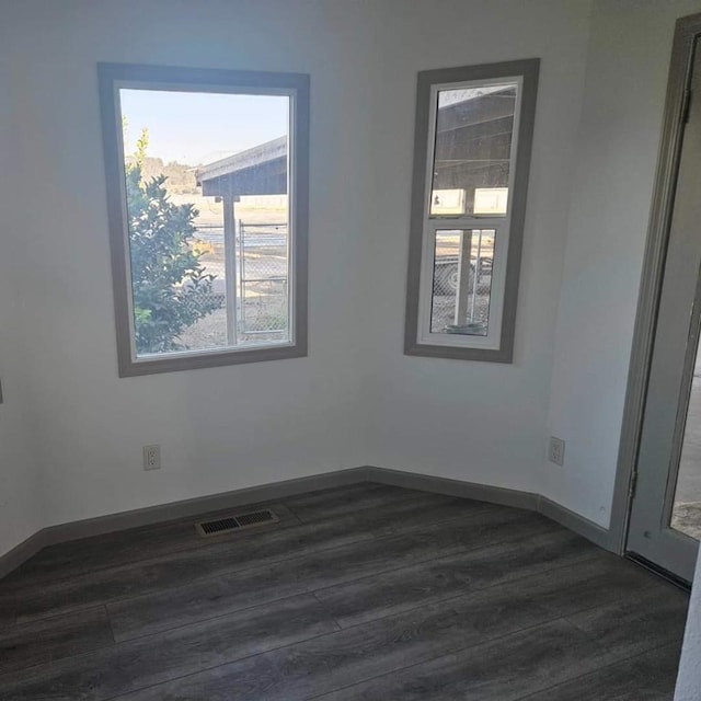 spare room featuring dark wood-type flooring