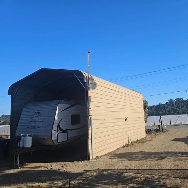 view of outbuilding with a water view and a carport