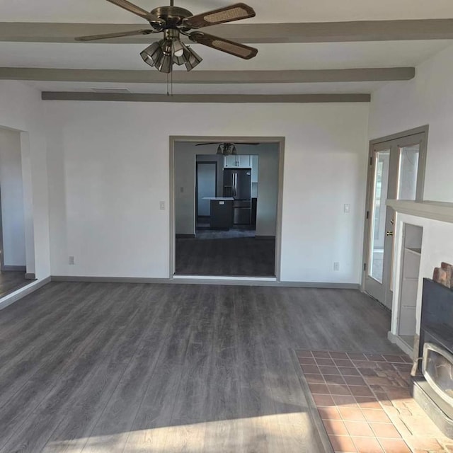 unfurnished living room featuring ceiling fan, dark hardwood / wood-style flooring, and beamed ceiling