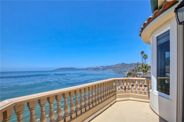 balcony with a water and mountain view