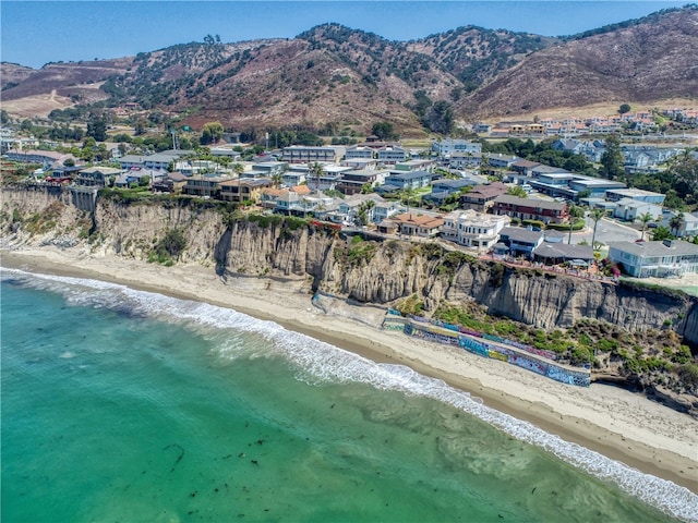 birds eye view of property with a water and mountain view and a view of the beach