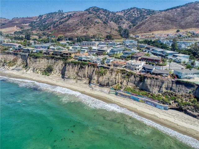 bird's eye view with a water and mountain view, a residential view, and a view of the beach