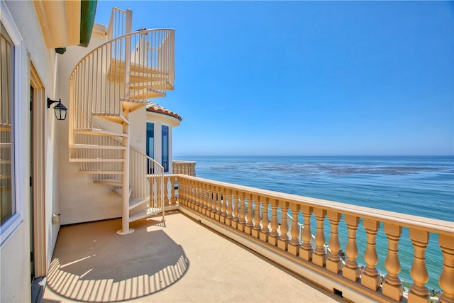 balcony featuring a water view