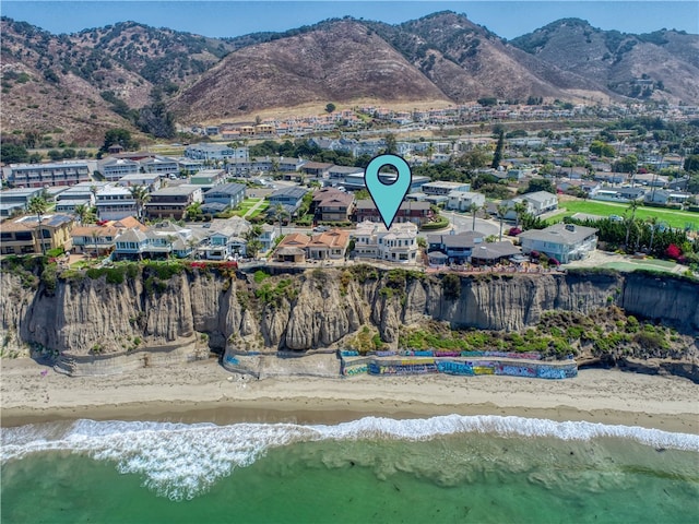 drone / aerial view featuring a water and mountain view