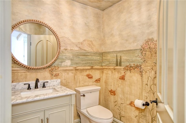 bathroom with toilet and vanity
