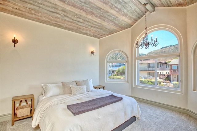 bedroom featuring an inviting chandelier, lofted ceiling with beams, carpet floors, wooden ceiling, and baseboards