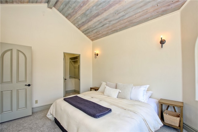 bedroom featuring wood ceiling, a closet, lofted ceiling, a walk in closet, and light colored carpet