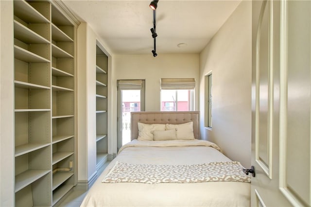bedroom featuring track lighting