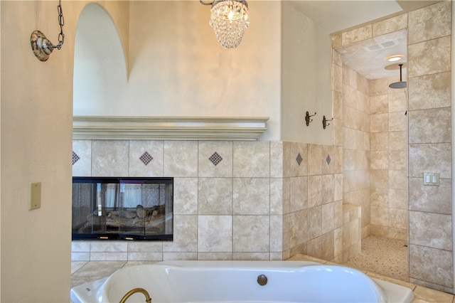 full bath featuring a tile shower, a fireplace, and a garden tub