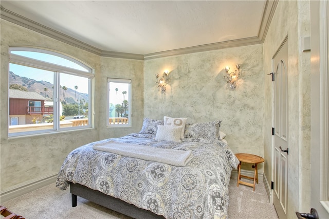 carpeted bedroom featuring a mountain view and crown molding