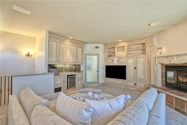 living area featuring visible vents, light colored carpet, and wine cooler