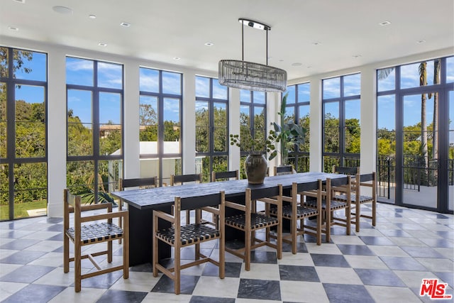 sunroom featuring a chandelier