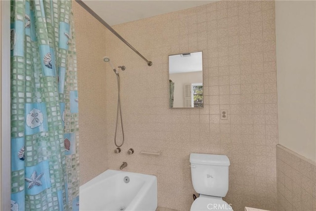 bathroom featuring shower / bath combo with shower curtain, tile walls, and toilet