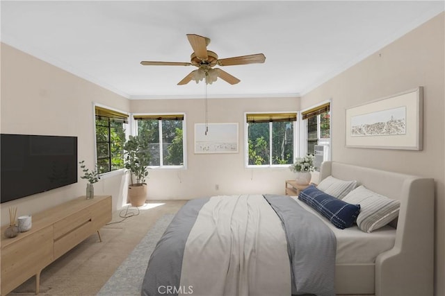 bedroom featuring ceiling fan, crown molding, and light carpet