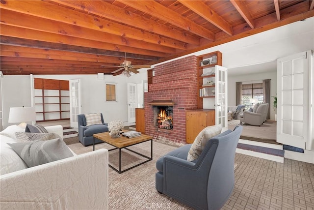 living room featuring french doors, a brick fireplace, ceiling fan, beam ceiling, and wooden ceiling