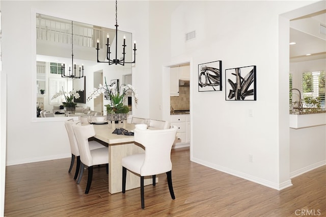 dining room featuring an inviting chandelier and dark hardwood / wood-style flooring