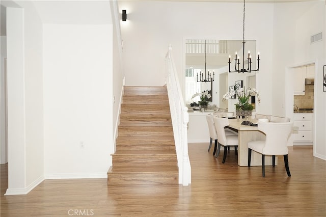 dining area with an inviting chandelier and hardwood / wood-style flooring