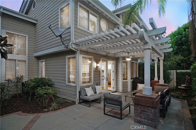 patio terrace at dusk with a pergola and an outdoor hangout area