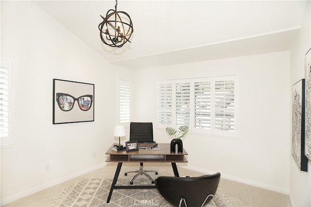 carpeted home office featuring a notable chandelier and lofted ceiling