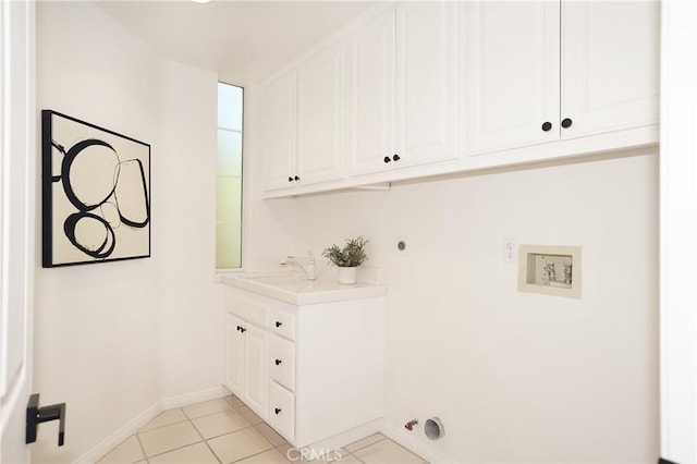 washroom featuring cabinets, hookup for a washing machine, light tile patterned flooring, and gas dryer hookup