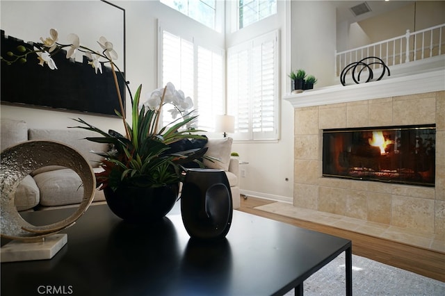 interior space featuring wood-type flooring and a tiled fireplace