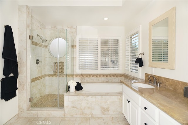 bathroom featuring plus walk in shower and vanity