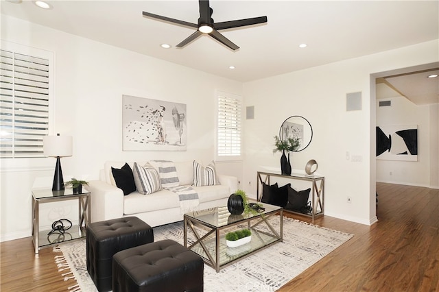 living room with hardwood / wood-style floors and ceiling fan