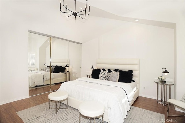 bedroom featuring wood-type flooring, high vaulted ceiling, and a closet