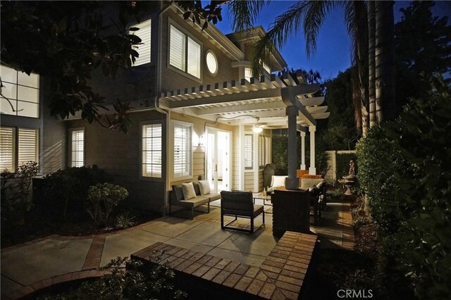 patio at twilight with a pergola and outdoor lounge area