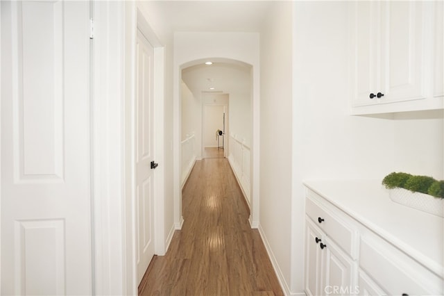 hallway with dark hardwood / wood-style flooring