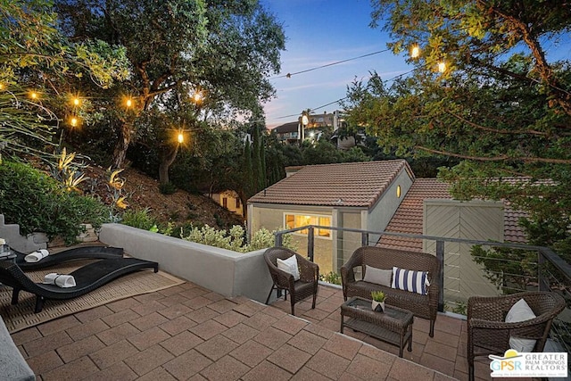 view of patio terrace at dusk