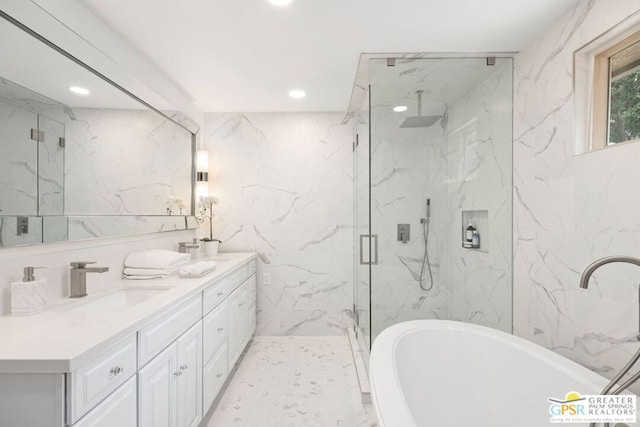 bathroom with tile walls, vanity, and separate shower and tub